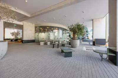 a lobby with benches and tables in a building at Mood Living 22 in Dubai