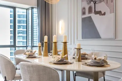 a dining room with a white table and chairs at The Smart Concierge - Southridge 1 in Dubai