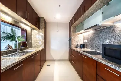 a kitchen with wooden cabinets and a sink at The Smart Concierge - Southridge 1 in Dubai