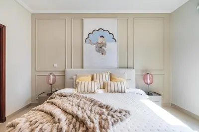 a bedroom with a large white bed with a blanket at The Smart Concierge - Southridge 1 in Dubai