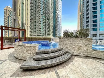 a fountain in a city with tall buildings at The Smart Concierge - Princess tower in Dubai