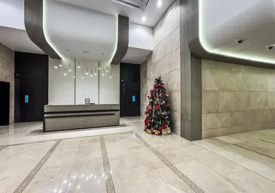 a christmas tree in the middle of a lobby at DreamShoma -2BR Deluxe Downtown Skyview in Dubai
