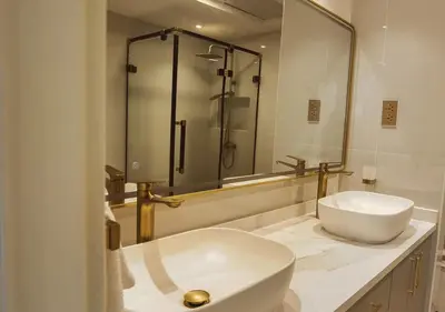 a bathroom with a toilet and a sink and a shower at DreamShoma -2BR Deluxe Downtown Skyview in Dubai