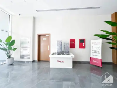 a room with a exhibit with buildings on the wall at Stunning 1B With Balcony & City Views - Dubai in Dubai