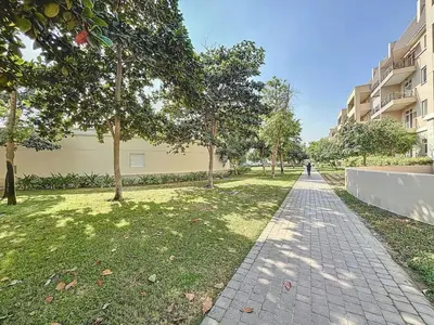 a walkway in a park next to a building at Widcombe House - Tranquil One Bed in Motor City in Dubai