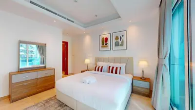 a bedroom with a white bed and a window at Orra Tower - Stunning One Bed with Marina View in Dubai