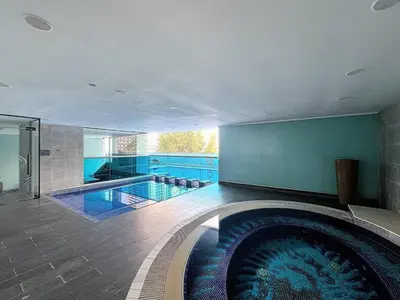 a large swimming pool in a house with a swimming pool at Orra Tower - Stunning One Bed with Marina View in Dubai