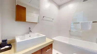 a white bathroom with a sink and a tub at Orra Tower - Stunning One Bed with Marina View in Dubai
