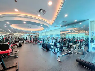 a gym with lots of cardio equipment in a building at Orra Tower - Stunning One Bed with Marina View in Dubai
