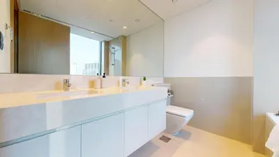 a bathroom with a sink and a toilet and a mirror at Vacationer l Marvel Super Hero Themed 3 Bedroom l Dubai Fountain Views in Downtown in Dubai