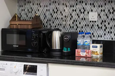 a microwave sitting on top of a kitchen counter at Famous Infinity Pool 64th floor near Burj Khalifa in Dubai