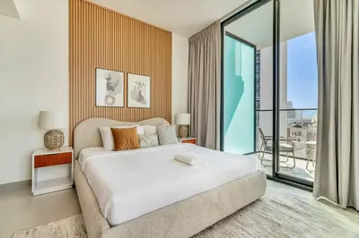 a bedroom with a large bed and a large window at GuestReady - Prestigious haven in JVC in Dubai