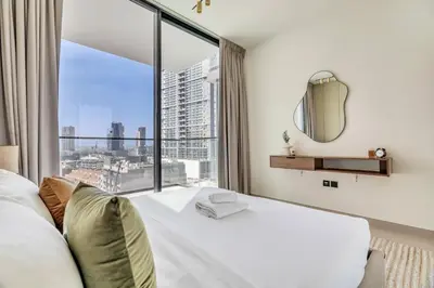 a bedroom with a bed and a large window at GuestReady - Prestigious haven in JVC in Dubai