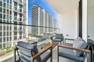 a balcony with two chairs and a table at GuestReady - Prestigious haven in JVC in Dubai