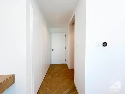 a hallway with a white door and a wooden floor at Spacious 2B Apt with Full Marina Views - Delphine in Dubai