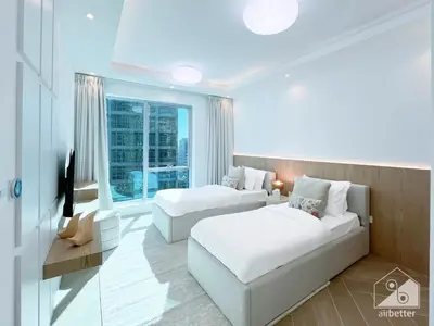 a hotel room with two beds and a couch at Spacious 2B Apt with Full Marina Views - Delphine in Dubai