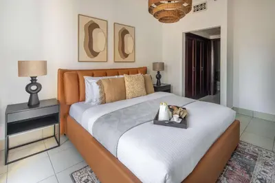 a bedroom with a bed with a dog sitting on it at Frank Porter - Reehan 7 in Dubai