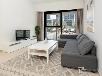 a living room with a couch and a table at Stylish 1BR in Act One, Downtown Near Burj Khalifa in Dubai