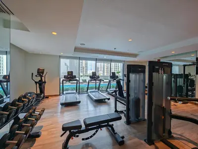a gym with treadmills and exercise equipment in a building at Stylish 1BR in Act One, Downtown Near Burj Khalifa in Dubai