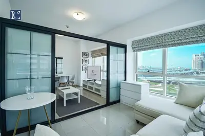 a living room with a couch and a table at Cozy 1-Bedroom Apartment in N2 Lakepoint Tower JLT in Dubai