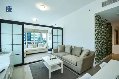a living room with a couch and a table at Cozy 1-Bedroom Apartment in N2 Lakepoint Tower JLT in Dubai