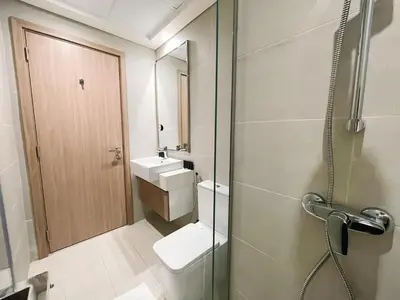 a bathroom with a toilet and a sink and a shower at Brand New Spacious 3-BedroomIAzizi Riviera 16 in Dubai
