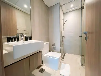a bathroom with a sink and a toilet and a shower at Brand New Spacious 3-BedroomIAzizi Riviera 16 in Dubai