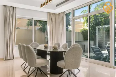 a dining room with a table and chairs at keysplease 4 BR Villa private pool, Jumeirah Park in Dubai