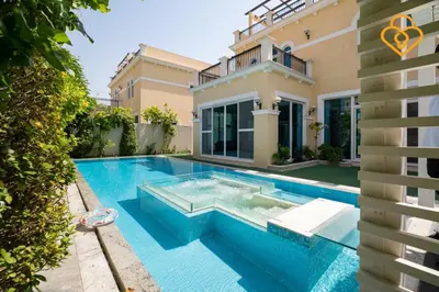 a swimming pool in front of a house at keysplease 4 BR Villa private pool, Jumeirah Park in Dubai