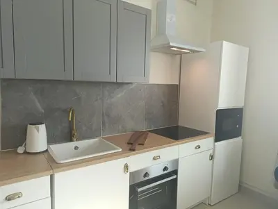 a kitchen with white cabinets and a sink at In the heart of Dubai in Dubai