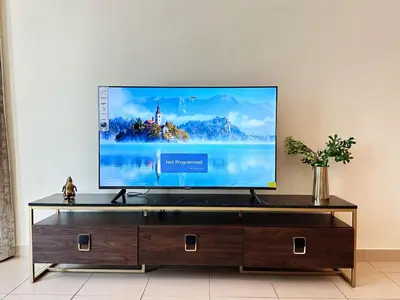 a flat screen tv sitting on top of a entertainment center at Step into Sophistication - Stylish 1-BR Apartment in Downtown Dubai by petals Holiday Homes in Dubai