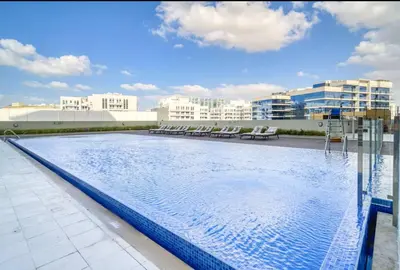 a large swimming pool on top of a building at Vogue Arjan Jwelz by Danube near Miracle and Butterfly Garden, Studio Apartment with Balcony and Vibrant Community View, Access to all Amenities in Dubai