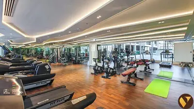 a gym with a bunch of treadmills and exercise bikes at Vogue Arjan Jwelz by Danube near Miracle and Butterfly Garden, Studio Apartment with Balcony and Vibrant Community View, Access to all Amenities in Dubai