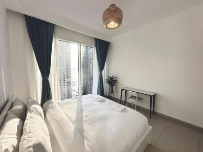 a bedroom with a bed and a large window at Coastal Charm - Fully Furnished 2-Bedroom Apartment with Spectacular Views by Petals Holiday Homes in Dubai