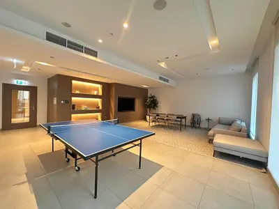 a living room with a ping pong table in it at Coastal Charm - Fully Furnished 2-Bedroom Apartment with Spectacular Views by Petals Holiday Homes in Dubai
