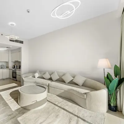 a white living room with a couch and a table at Park Point C-1 bedroom for monthly stay-1005 in Dubai