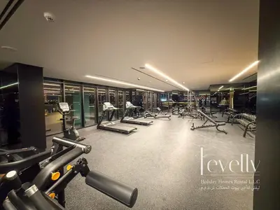 a gym with treadmills and machines in a building at Urban Oasis by Missoni Brand NEW Luxury in Dubai
