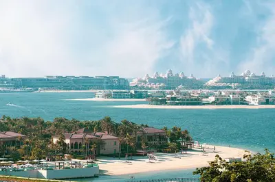 a view of a beach with buildings and the ocean at Seaside Serenity 1Bd Beachfront Apartment in Dubai