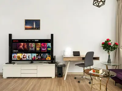 a living room with a large tv on a wall at Spacious 3BR High Floor Palm View in Dubai Marina in Dubai