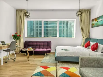 a bedroom with a bed and a purple couch at Spacious 3BR High Floor Palm View in Dubai Marina in Dubai