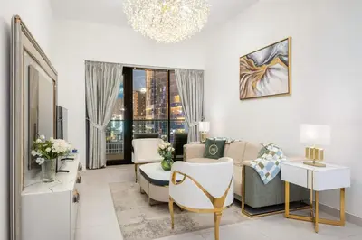 a living room with a couch and a table at Elegant 2BR with Balcony and Burj Khalifa Skyline Views in Dubai