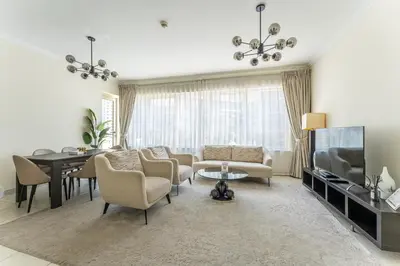 a living room with a couch and a table and a tv at HAVN - 2 Bedroom in Marina Quays, Dubai Marina in Dubai
