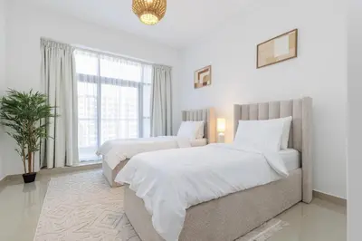 a bedroom with two beds and a large window at Huge Sky Villa With Panoramic Golf Views in Dubai
