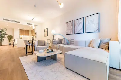 a living room with a couch and a table at Revamped 1BR Unit with Partial Sea & Palm Jumeirah Views Close to Beach , Elite Residence, Dubai Marina by Deluxe Holiday Homes in Dubai