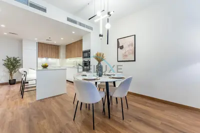 a dining room and kitchen with a table and chairs at Revamped 1BR Unit with Partial Sea & Palm Jumeirah Views Close to Beach , Elite Residence, Dubai Marina by Deluxe Holiday Homes in Dubai