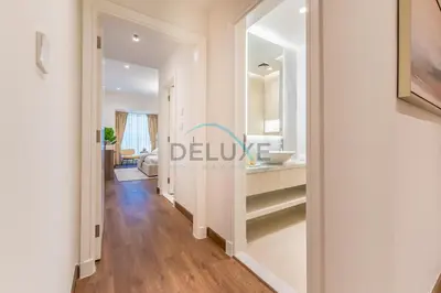 a corridor of a bathroom with a sink and a mirror at Revamped 1BR Unit with Partial Sea & Palm Jumeirah Views Close to Beach , Elite Residence, Dubai Marina by Deluxe Holiday Homes in Dubai