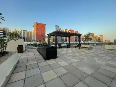 a pavilion in a city with buildings in the background at Pool Views 1BR Close to Major Landmarks in Azizi Riviera 18, Al Merkadh by Deluxe Holiday Homes in Dubai
