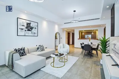 a living room with a couch and a table at Exclusive 2BR Home Marina Residence 4, The Palm in Dubai
