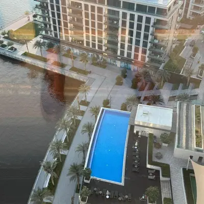 an overhead view of a building with a swimming pool at THE COVE Creek Harbour in Dubai
