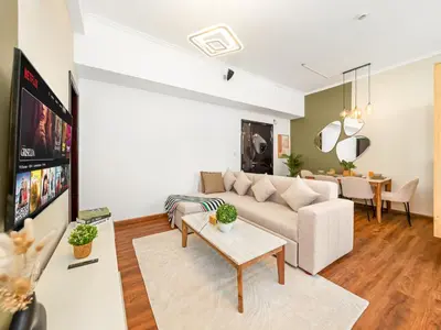 a living room with a couch and a table at Spacious High Floor Apartment Dubai Marina in Dubai